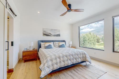 a bedroom with a bed and a large window at Alpine Vista Haven in Silverthorne