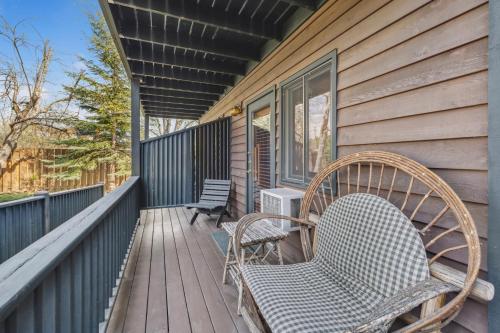 a couple of chairs sitting on a porch at Good Medicine Lodge in Whitefish