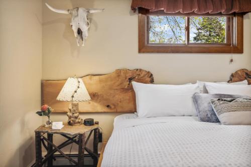 a bedroom with two beds and a skull on the wall at Good Medicine Lodge in Whitefish