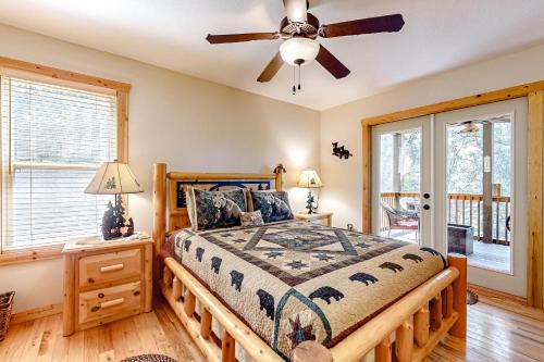 a bedroom with a bed and a ceiling fan at Tranquil Paradise in Ellijay