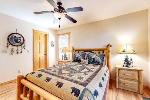 a bedroom with a bed and a ceiling fan at Tranquil Paradise in Ellijay