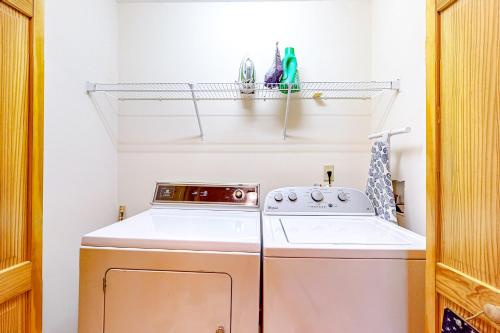 a small laundry room with a washer and dryer at Tranquil Paradise in Ellijay