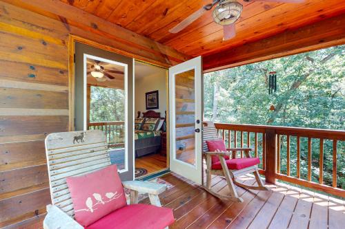 a porch with two rocking chairs on a wooden deck at Tranquil Paradise in Ellijay