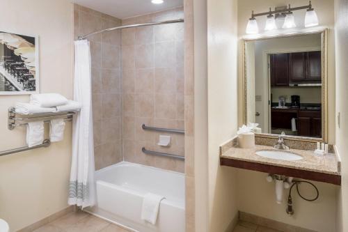 a bathroom with a tub and a shower and a sink at TownePlace Suites by Marriott San Antonio Airport in San Antonio