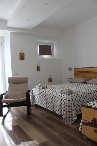 a bedroom with a bed and a chair and a window at CaSAle in Castelfidardo