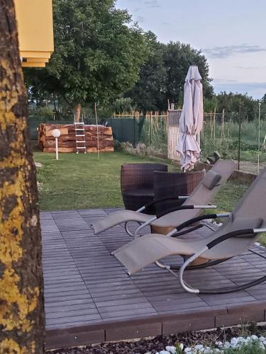 a group of chairs and an umbrella on a deck at CaSAle in Castelfidardo