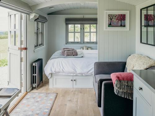 a small bedroom with a bed and a window at Phoebes Folly-uk36581 in Milton Abbot