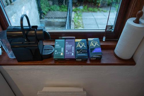 a shelf with books sitting on a window sill at Skylight Lodge in Horsens