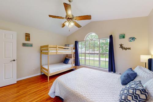 a bedroom with a bed and a ceiling fan at Sunny Sebastian in Sebastian