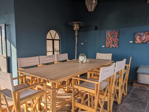 a dining room with a wooden table and chairs at La Joya Azul SMA - LGBTQS in San Miguel de Allende