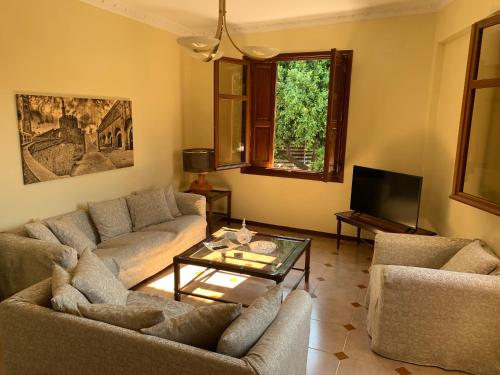 a living room with two couches and a coffee table at The Knights Courtyard in Rhodes Town