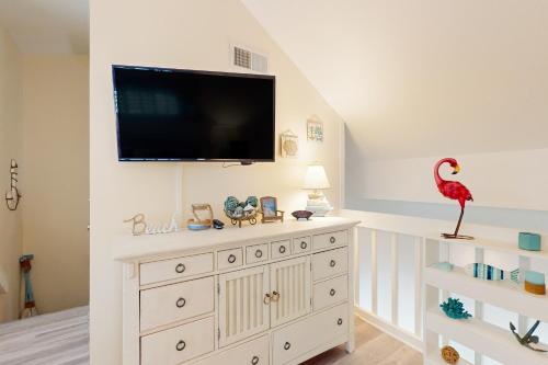 a room with a large white dresser with a television on it at Sand Dollar W202 in Pensacola Beach