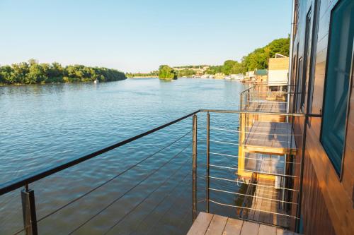 a boat on a river with a view of it at ArkaBarka 2- Floating Dream Rooms and Apartments in Belgrade
