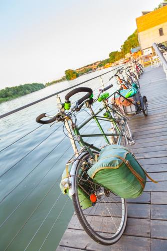 a group of bikes parked on a pier next to water at ArkaBarka 2- Floating Dream Rooms and Apartments in Belgrade