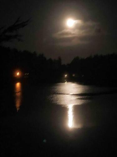 a full moon over a body of water at night at Hammersley Inlet- Oyster beach, Relaxing Views in Shelton