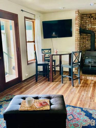 a living room with a couch and a table with chairs at Hammersley Inlet- Oyster beach, Relaxing Views in Shelton