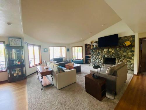a large living room with a stone wall at Hammersley Inlet- Oyster beach, Relaxing Views in Shelton