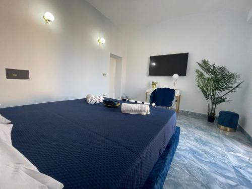 a bedroom with a blue bed and a tv at Luxury Blue House in Naples