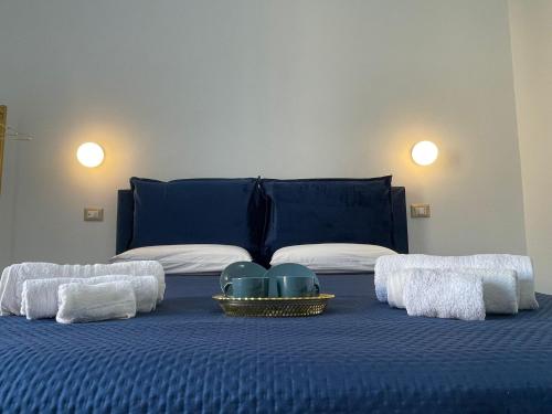 a blue bed with towels and a tray of dishes on it at Luxury Blue House in Naples
