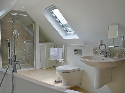 a bathroom with a sink and a toilet and a shower at Briar Cottage in Gargunnock