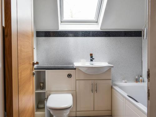 a bathroom with a sink and a toilet and a window at The Nook in Kirkby Lonsdale