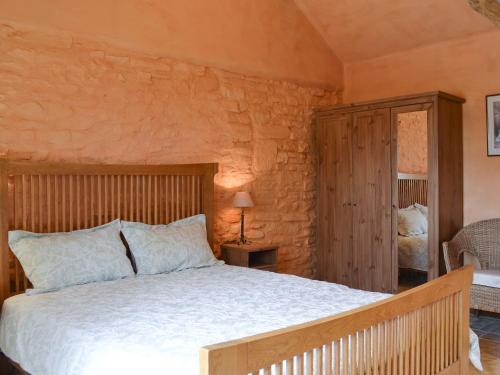 a bedroom with a large bed in a room at The Cart Shed in Kings Pyon