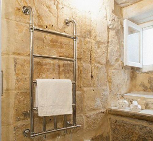 a bathroom with a shower with a towel on a towel rack at Dar Isla, in the heart of the Three Cities, Malta in Senglea