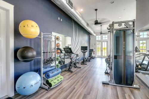 a gym with treadmills and exercise equipment in a room at Golf Course Living at Palmilla Beach in Port Aransas