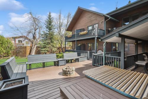 a deck with two benches on a house at Good Medicine Lodge in Whitefish