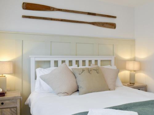 a bedroom with a white bed with white pillows at Sandgate Apartment in Sandgate