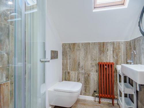 a bathroom with a toilet and a sink and a shower at Ystwyth House in Borth