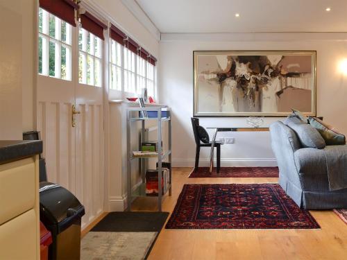 a living room with a couch and a desk at The Old Rectory Lodge in Yaxham