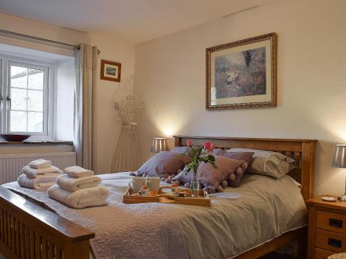 a bedroom with a bed with towels on it at Barn House in Settle