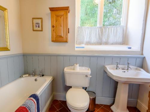 a bathroom with a tub and a toilet and a sink at St Andrews Church in East Barkwith