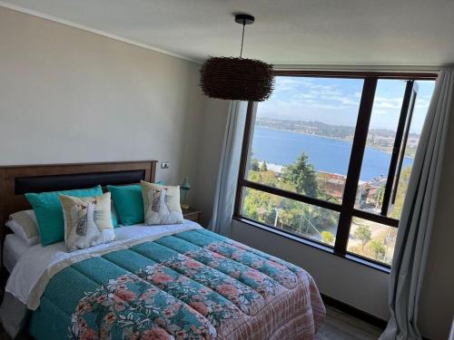 a bedroom with a bed and a large window at TuArriendoCL-MPHB402 Dpto con vista al Lago 2D2B hasta 5Pax in Puerto Varas