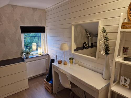 a home office with a desk and a mirror at Eldaren in Tranås