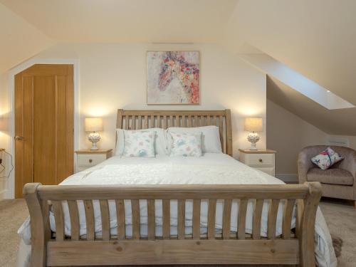 a bedroom with a bed with two lamps and a chair at Harbour View - Ukc2303 in Wainfleet All Saints
