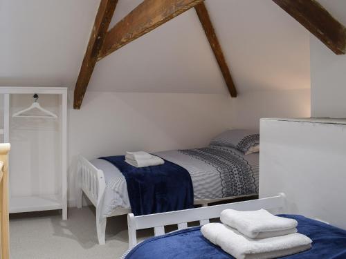 a bedroom with two twin beds and wooden beams at Cilwendeg Lodge in Newchapel