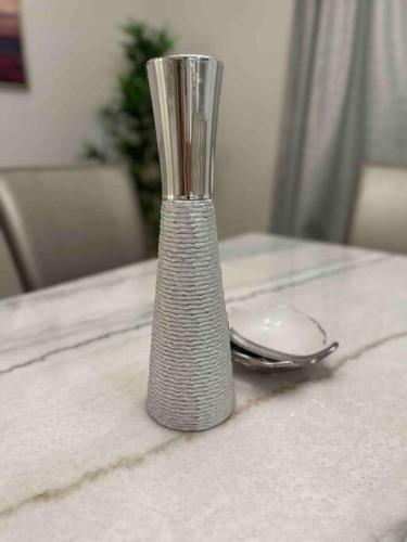 a silver vase sitting on top of a table at Stylish House W a Media Room Near Downtown Picton in Picton