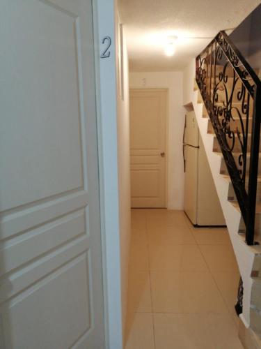 a door leading to a hallway with a staircase at (6)Cuarto ideal para descansar. in Tlazcalancingo