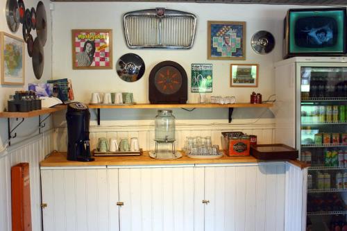 a room with a counter with plates and a clock on the wall at Twister 53 in Sparreholm