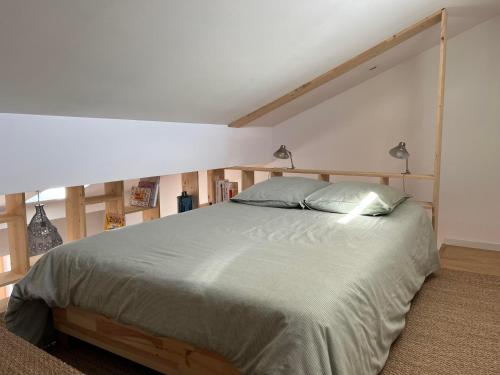 a bedroom with a large bed in a room at Suite Bergame in Caluire-et-Cuire