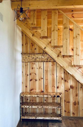 a room with a wooden wall with a ceiling at Nomad Lodge Zminica in Žabljak