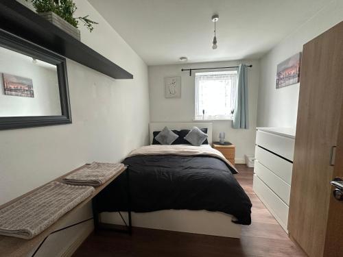 a small bedroom with a bed and a window at ABBA Heights in London