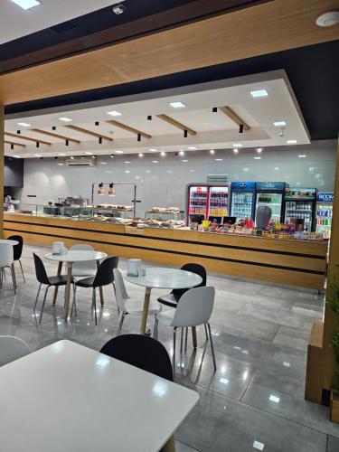a restaurant with tables and chairs and a counter at Galstyans Home EVN Airport in Yerevan