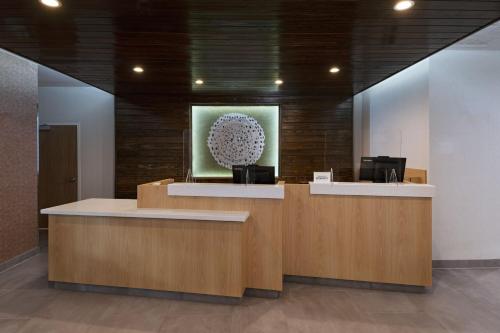 an office lobby with a reception desk and a picture at Fairfield by Marriott Inn & Suites Waller in Waller