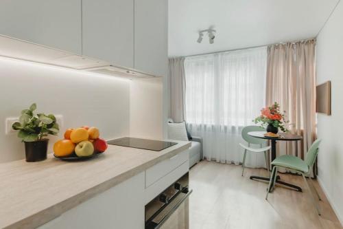 a kitchen with a bowl of fruit on a counter at Apartment in Žvėrynas in Vilnius