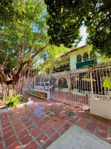a white fence in front of a house at Hostal Casa Tropicalia in Barranquilla