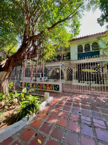 a white fence in front of a house at Hostal Casa Tropicalia in Barranquilla