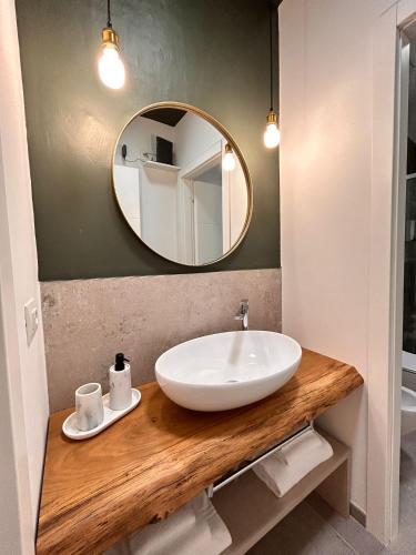 a bathroom with a sink and a mirror at La Loggia dei Mercanti in Cuneo